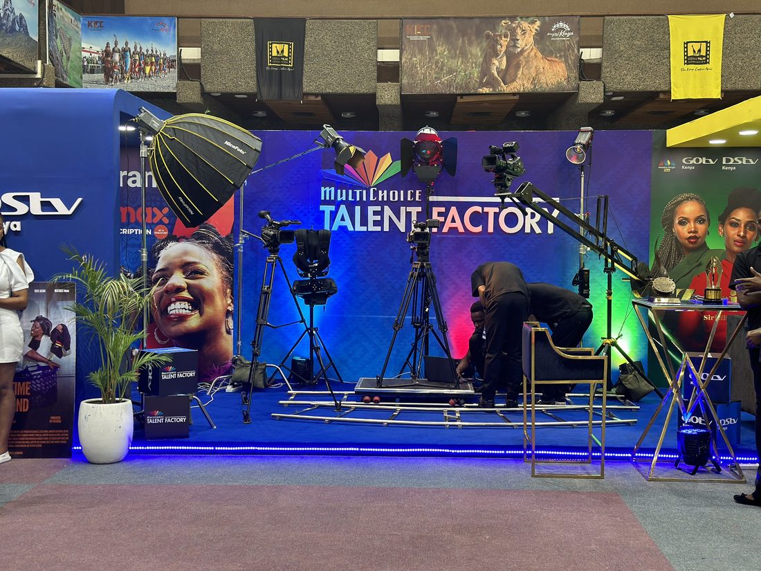 Crew working at a printed media wall with lighting stands in position