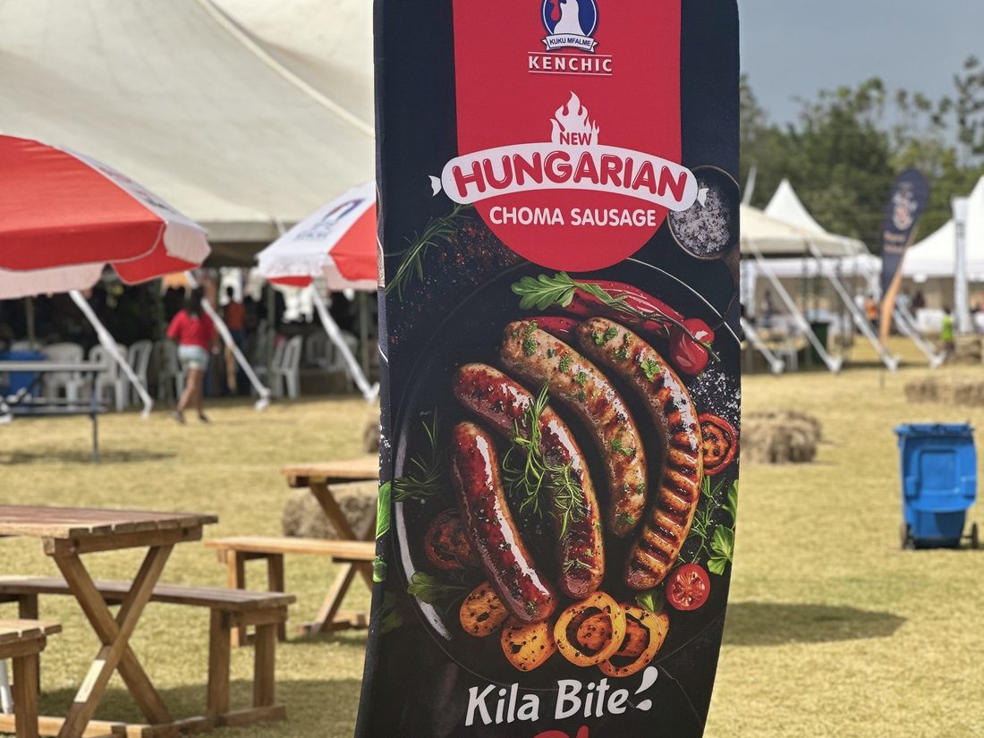 A freestanding Hungarian Choma Sausage totem on a lawn