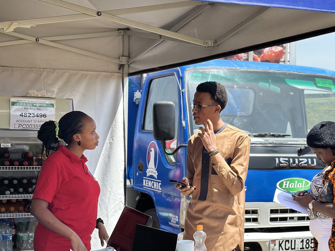 Staff working the service window of a branded mobile unit