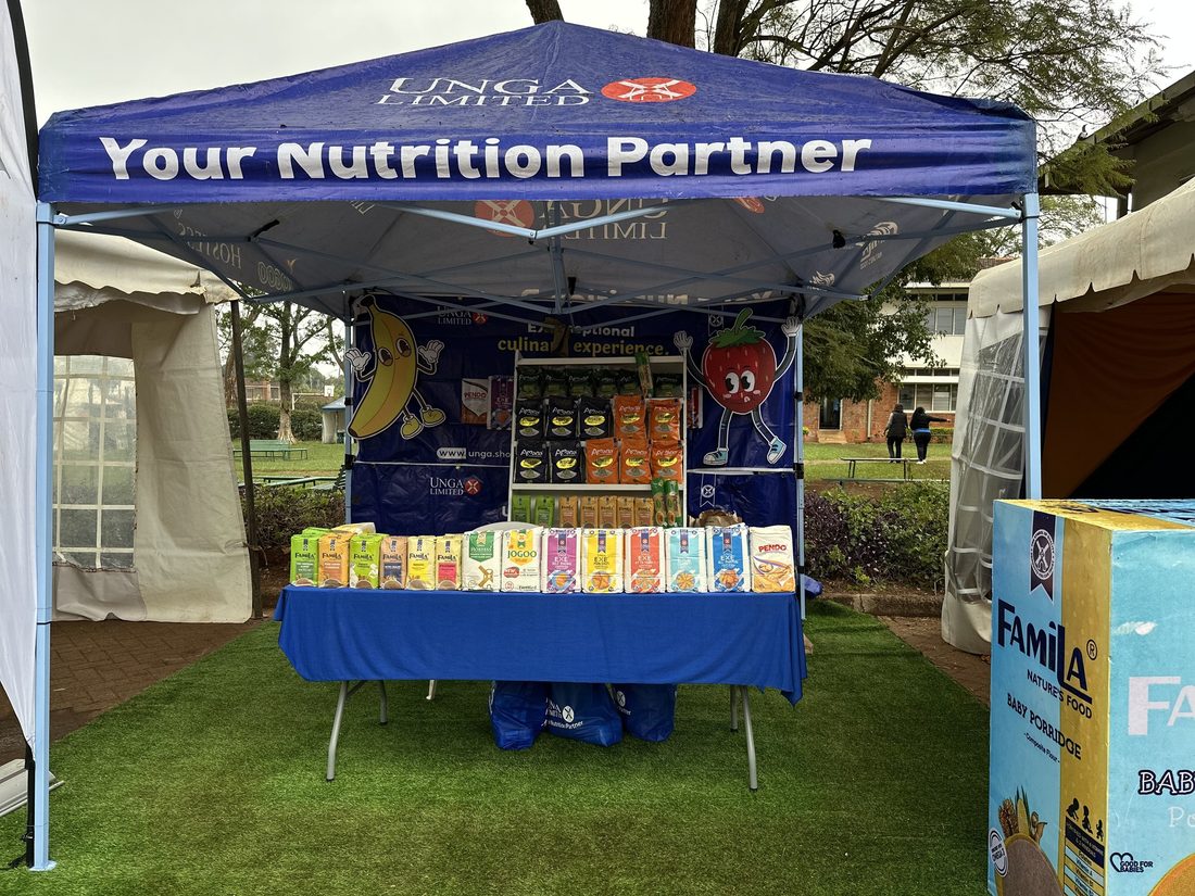 An Unga gazebo with a stocked product shelf on a lawn