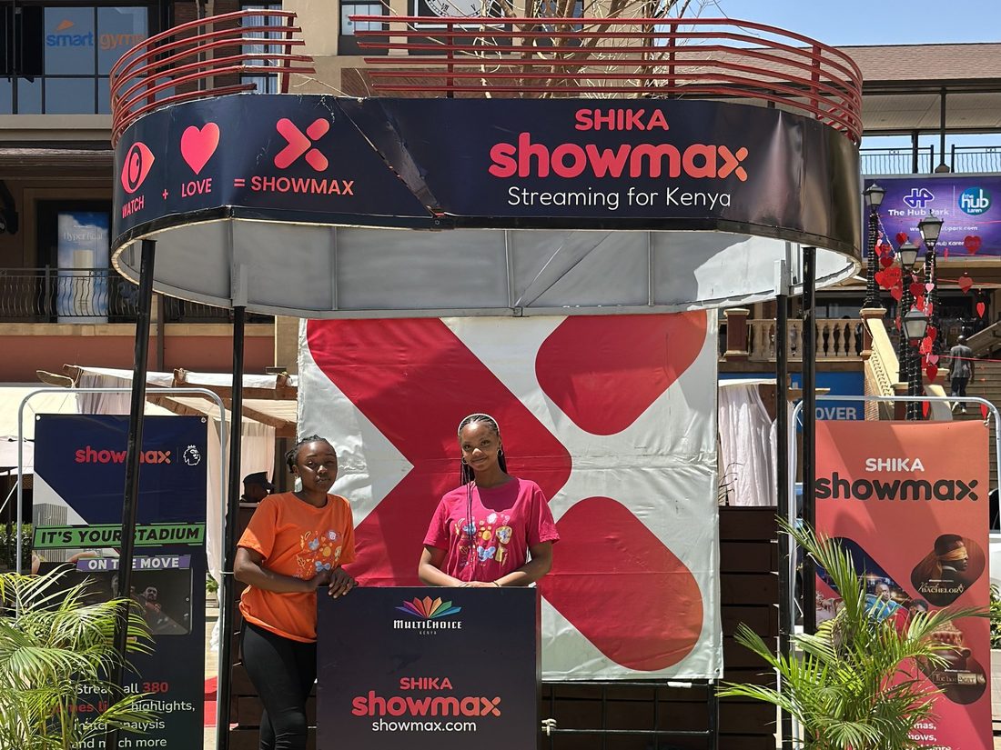 A Showmax mall activation with an overhead arch and a large sculptural X