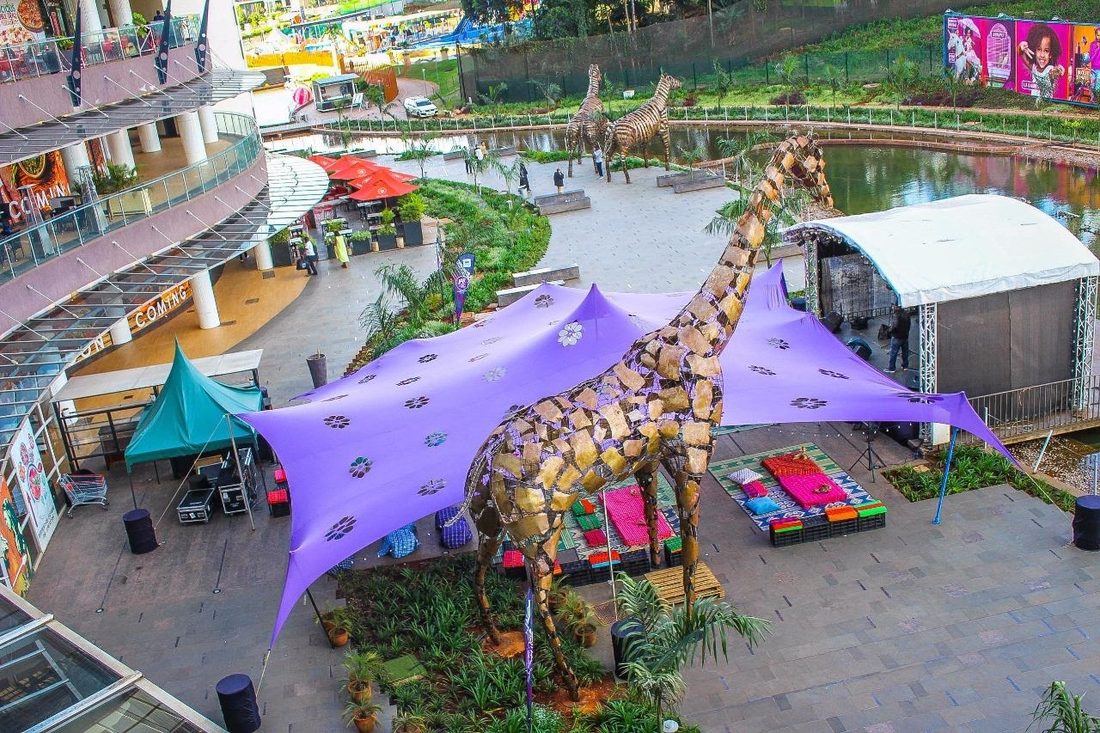 An elevated view of the stretch-tent build over a water garden