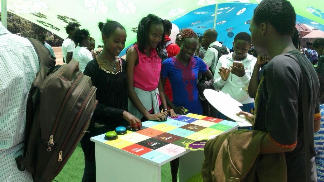 Students being served at a colour-blocked sampling table
