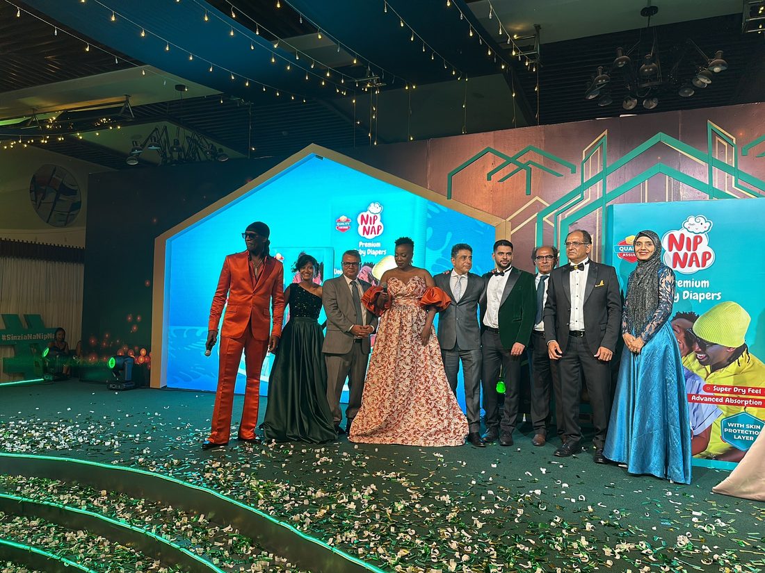 A group in formal dress standing together on a themed stage set