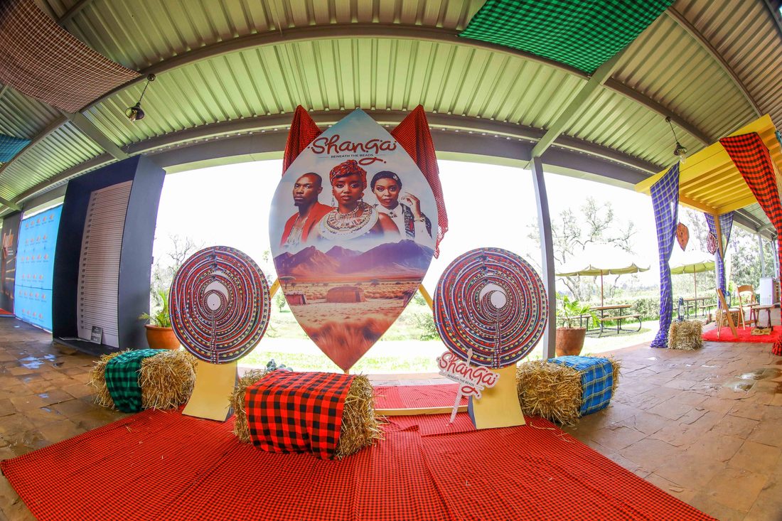 A themed entrance arch dressed with drums and hay bales