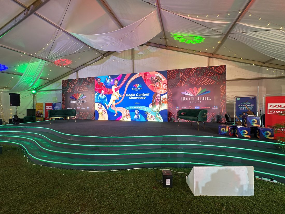 Tiered seating facing a large LED wall inside a marquee