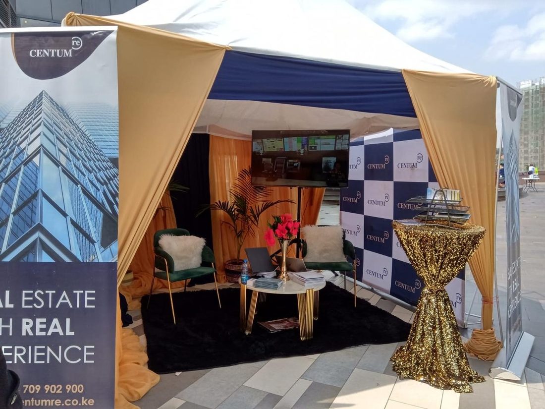 The interior of a branded marquee dressed as a lounge with a printed banner