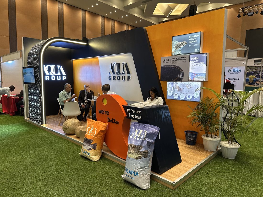 An Aqua Group exhibition stand with a lounge area and product displays