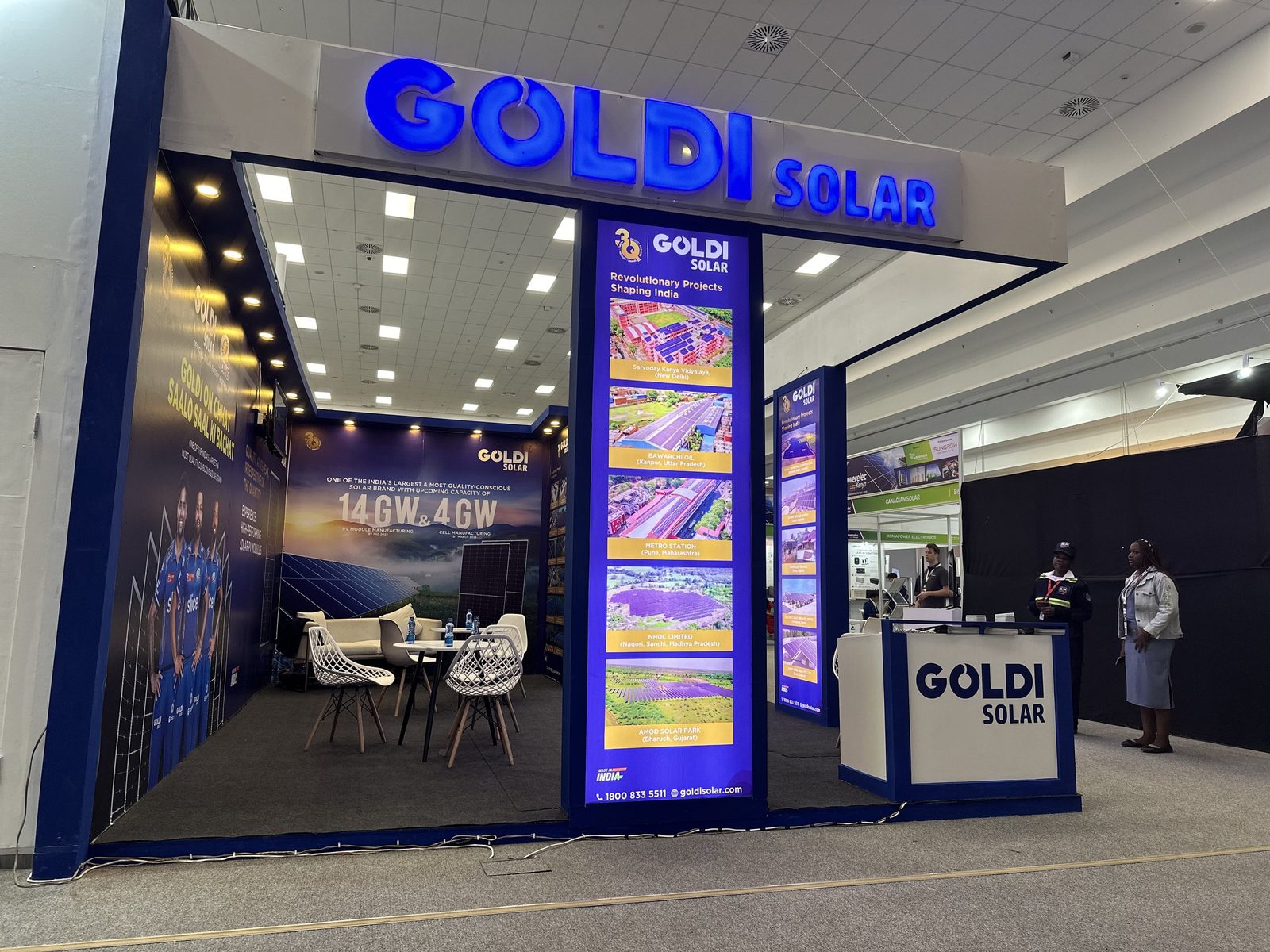 A Goldi Solar exhibition stand with an illuminated fascia and lightbox towers