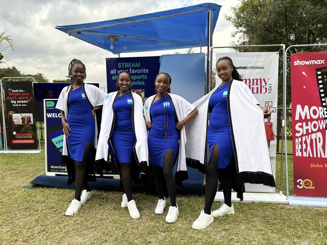 Three DStv Stream brand ambassadors standing in front of the stand