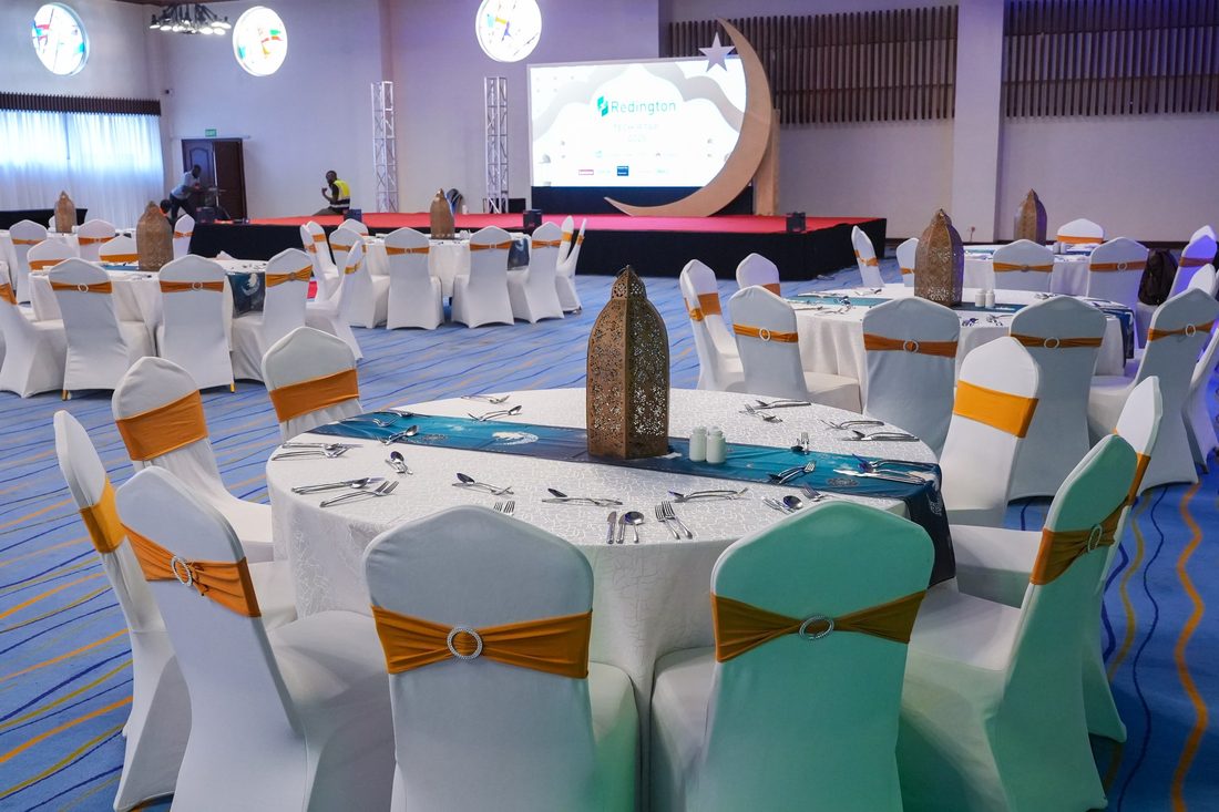 Banquet rounds dressed with chair covers and coloured sashes