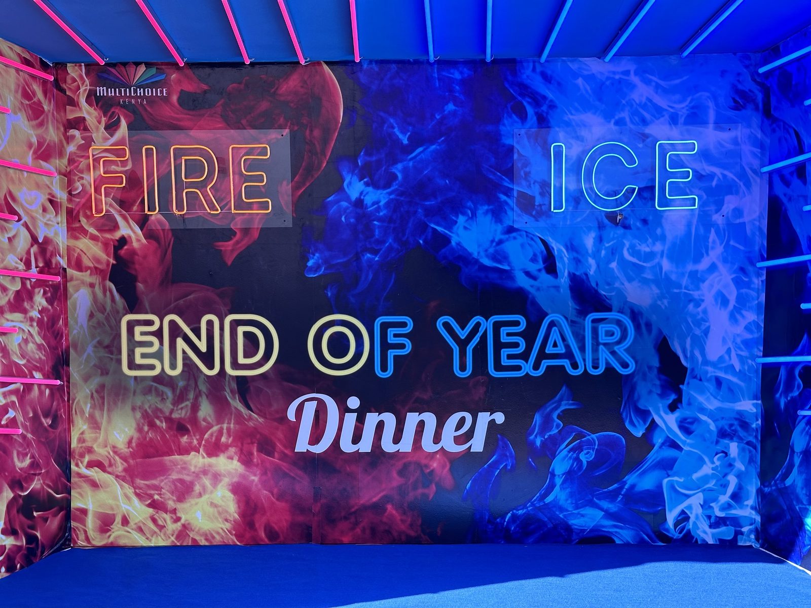 A full-width LED screen reading End of Year Dinner in a darkened room