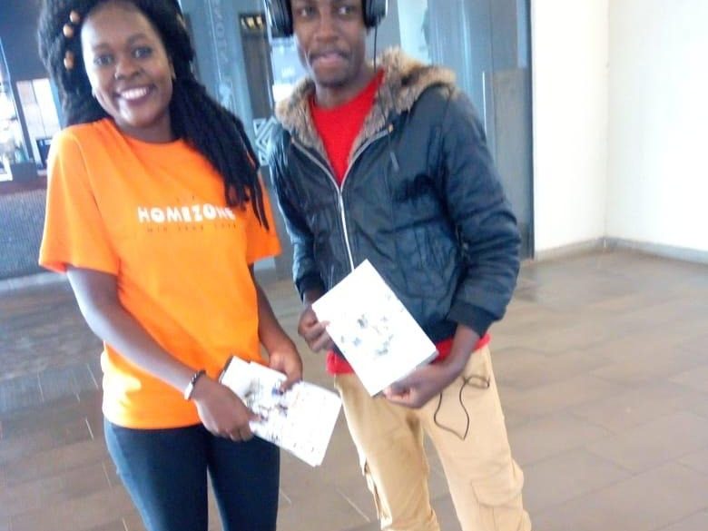 An ambassador and a consumer looking at a leaflet together