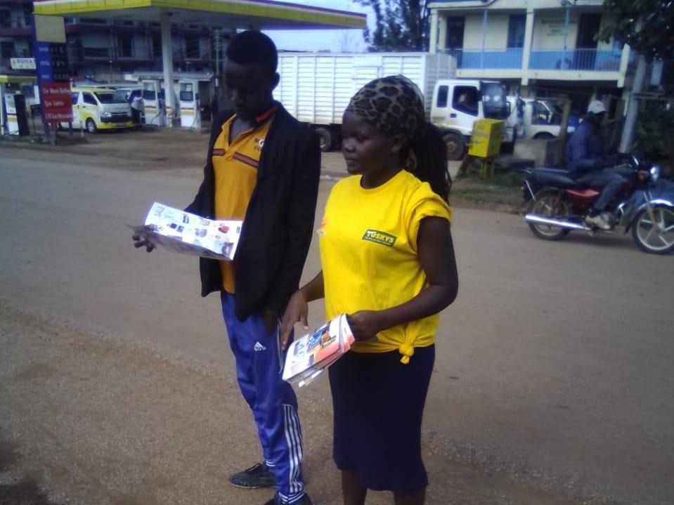A leaflet hand-off on a fuel-station forecourt