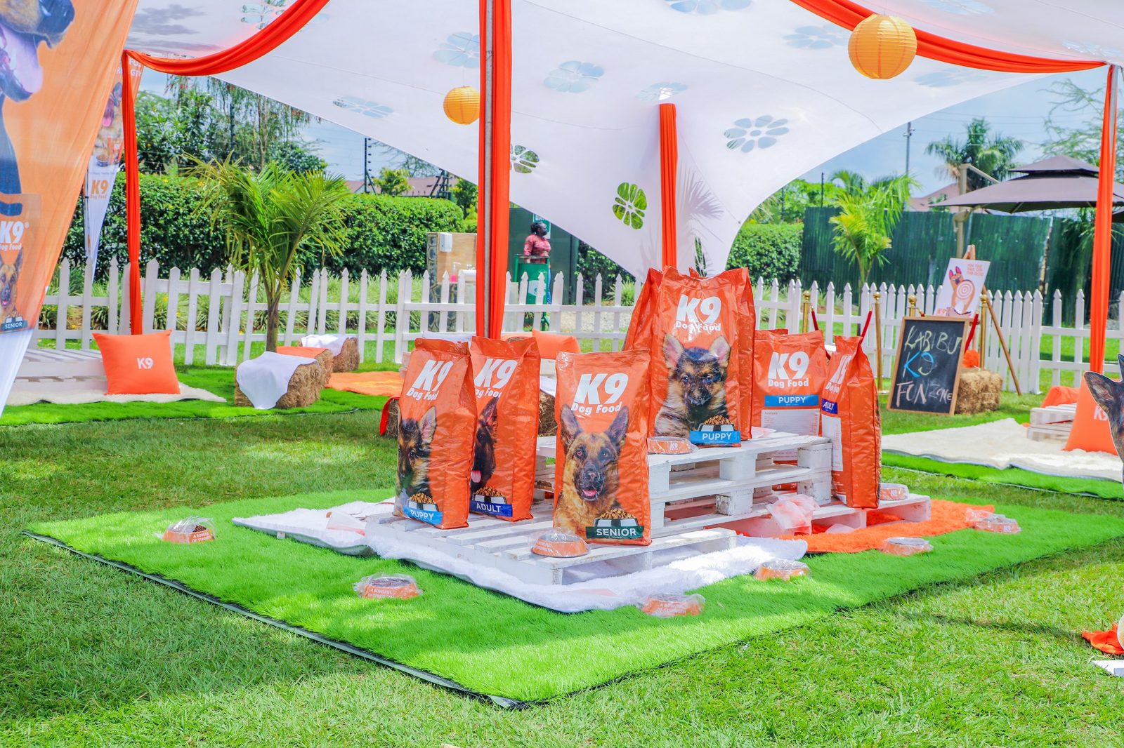 A garden product launch with stretch tents, a picket fence and a pallet plinth