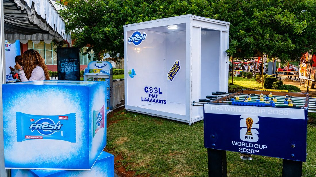 A Fresh photo cube and an ice plinth beside a branded foosball table on a lawn