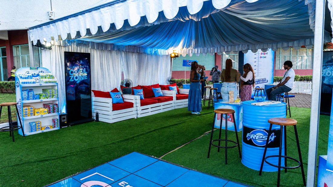 The Fresh Cool Zone lounge in use, pallet seating and a stocked product shelf under a draped marquee
