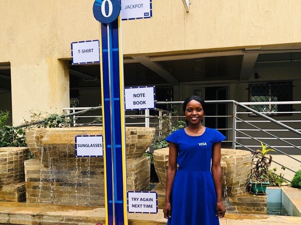 A brand ambassador beside a branded prize-game unit