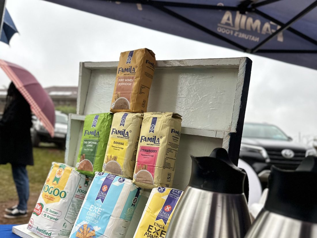 A product shelf and serving flasks set up under a gazebo