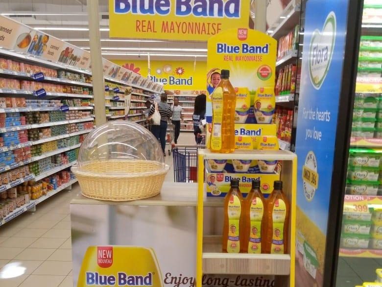 A Blue Band free-standing display unit standing clean in a supermarket aisle