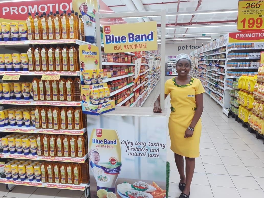 A Blue Band end-cap display in a supermarket aisle with price rails visible