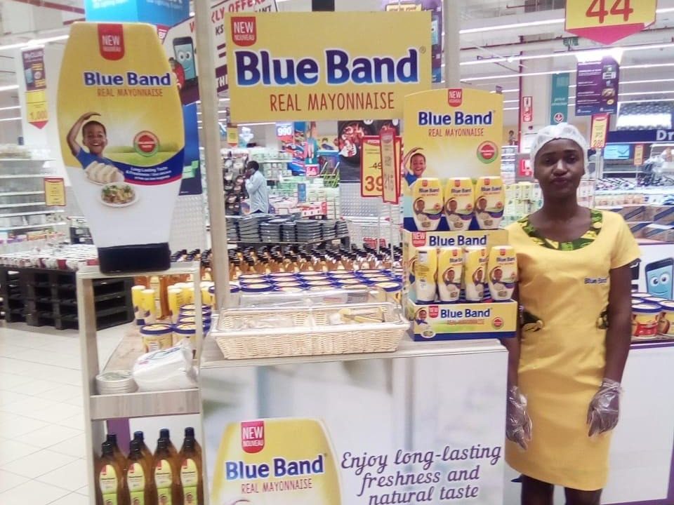 A promoter working at a free-standing display unit beneath a store loyalty rail