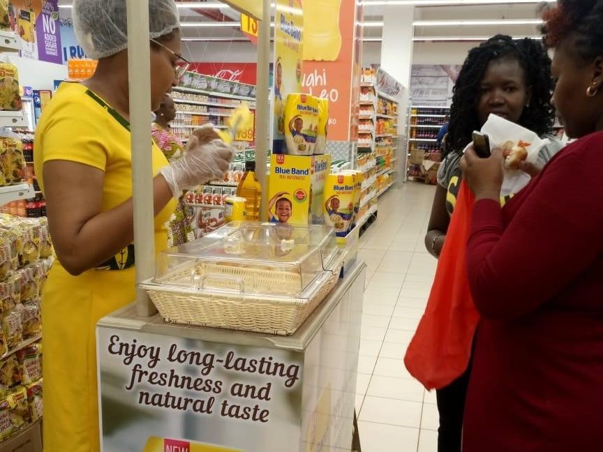 A promoter serving a shopper at the display unit