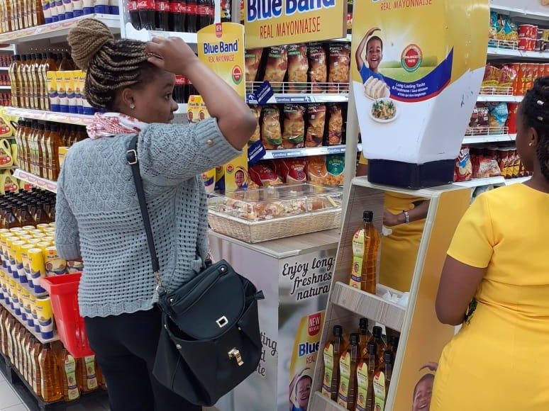 A shopper reaching into a branded display