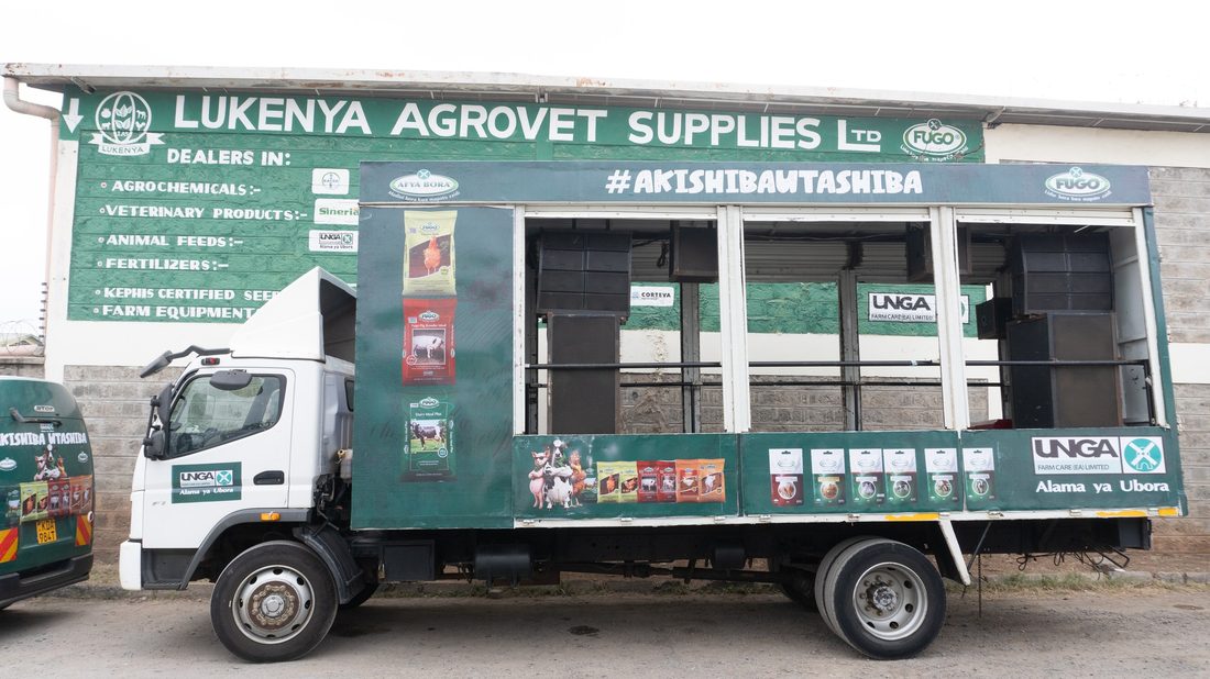 Side elevation of a route truck with product packs merchandised along the body