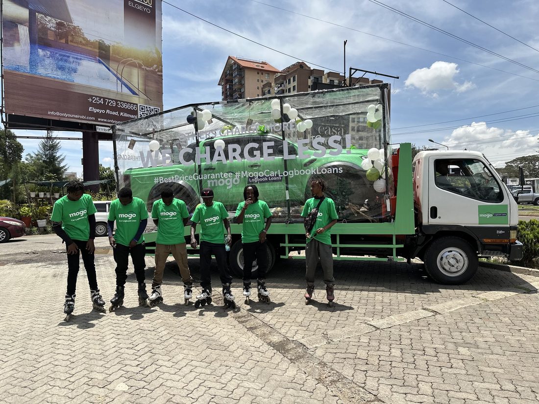 A field team lined up in front of a green branded truck