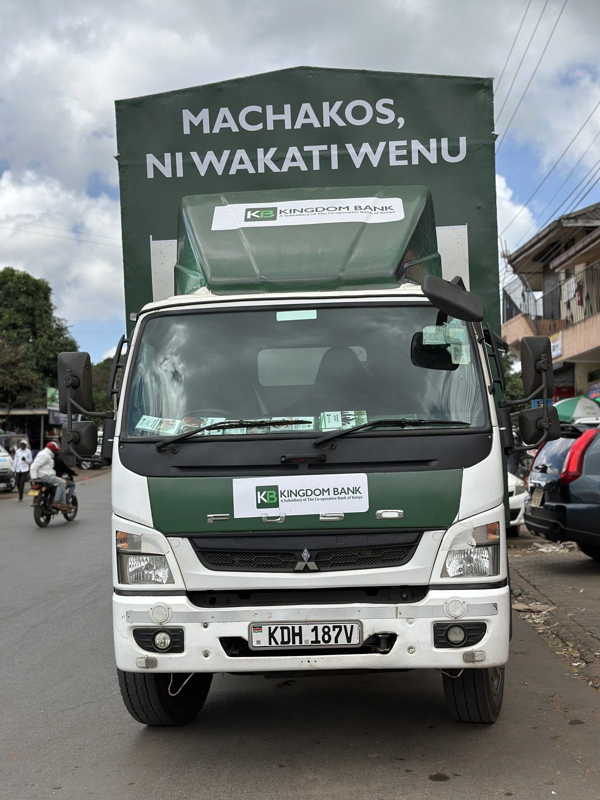 A branded roadshow truck photographed head-on in a town street