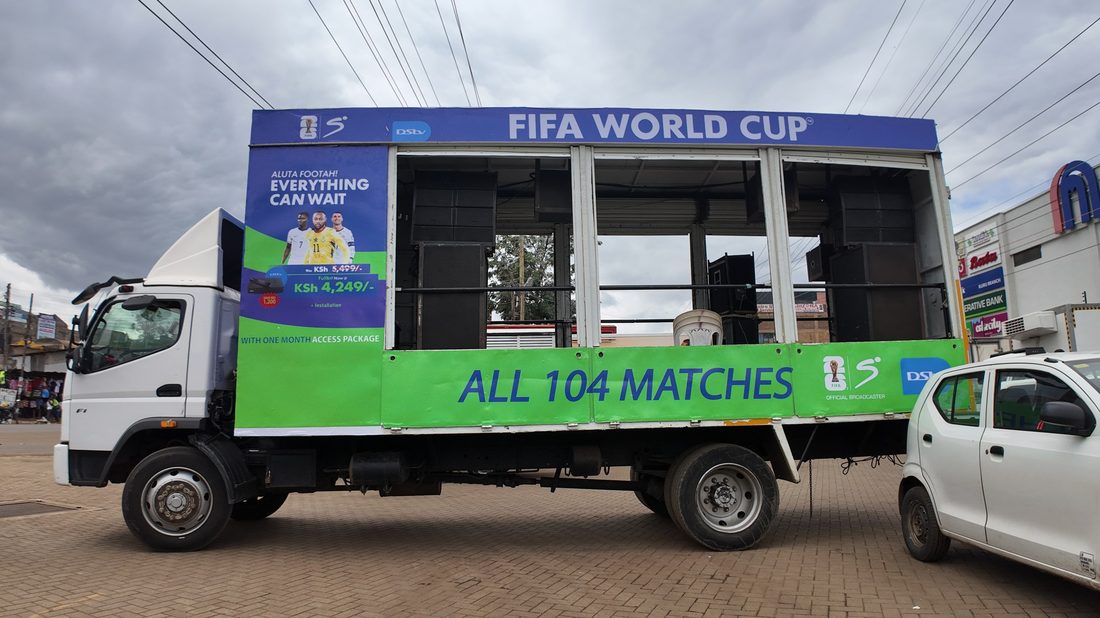 A route truck in full FIFA World Cup livery parked at a filling station forecourt