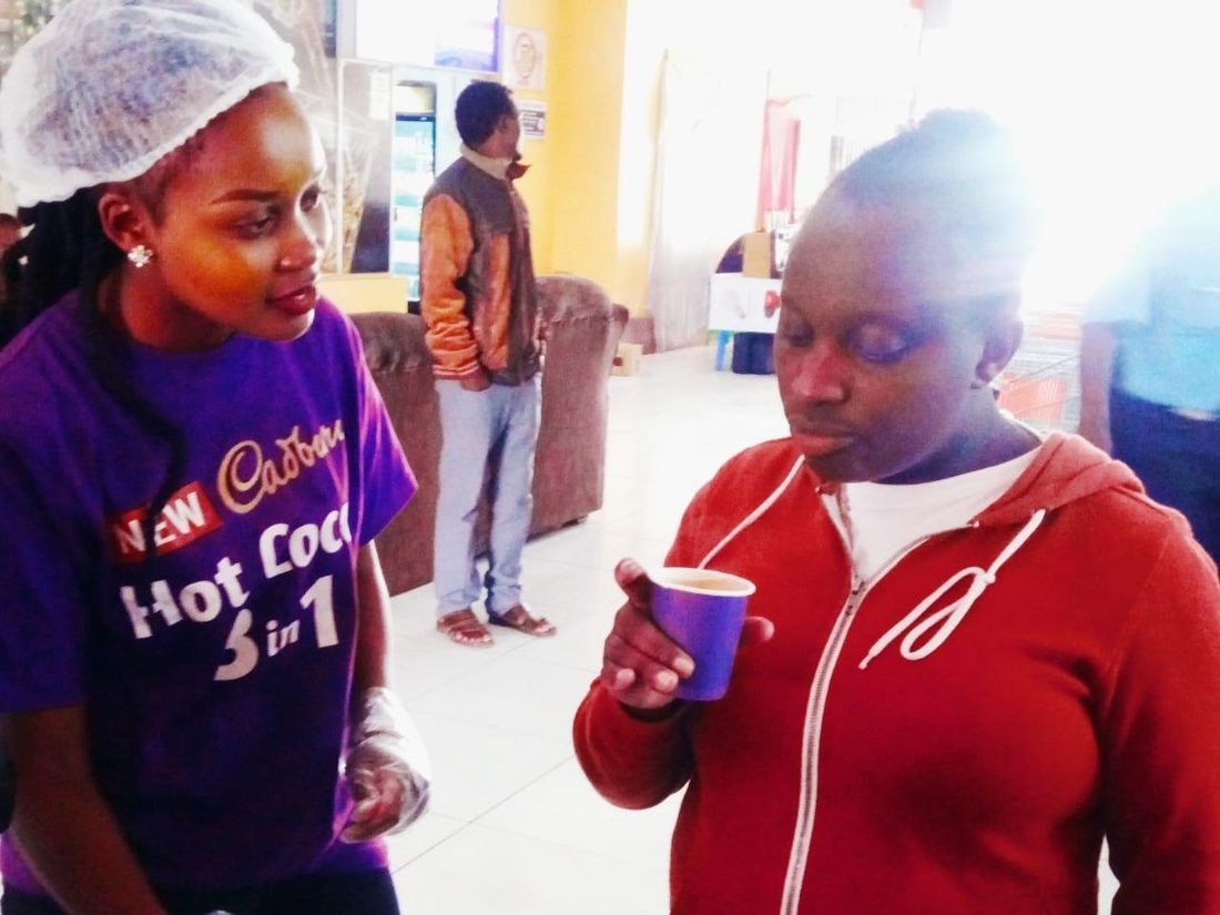 A consumer drinking a sample at the stand