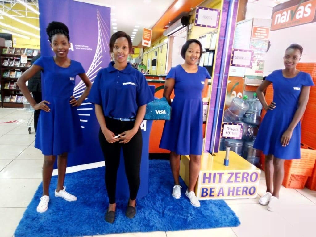Four VISA brand ambassadors either side of a branded game unit