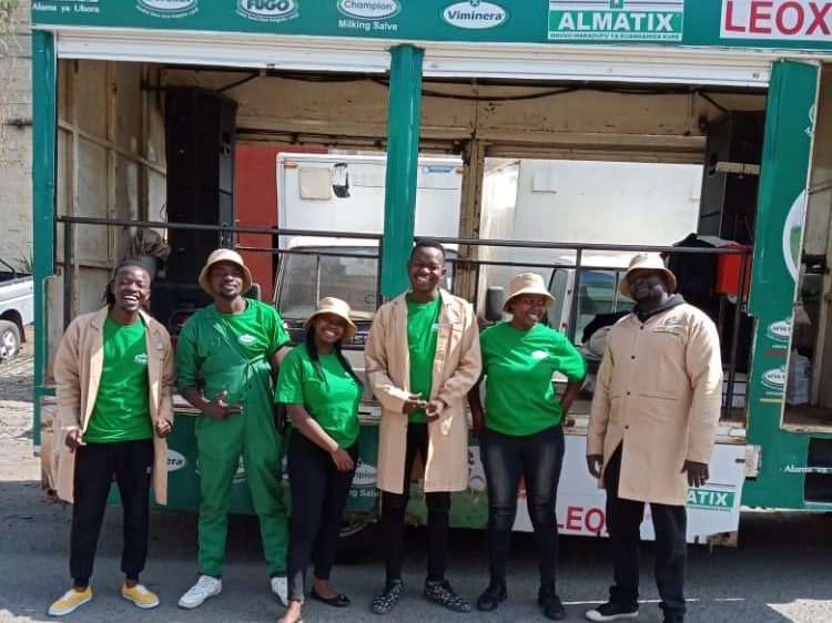A branded team standing outside an agrovet shopfront