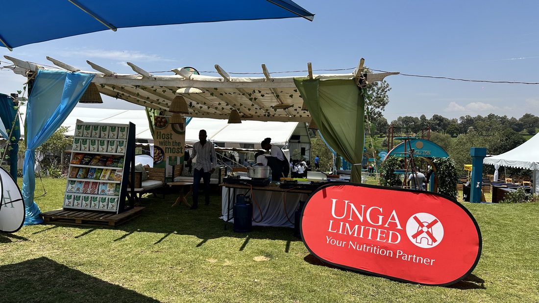 A stocked product shelf under a stretch tent on a lawn
