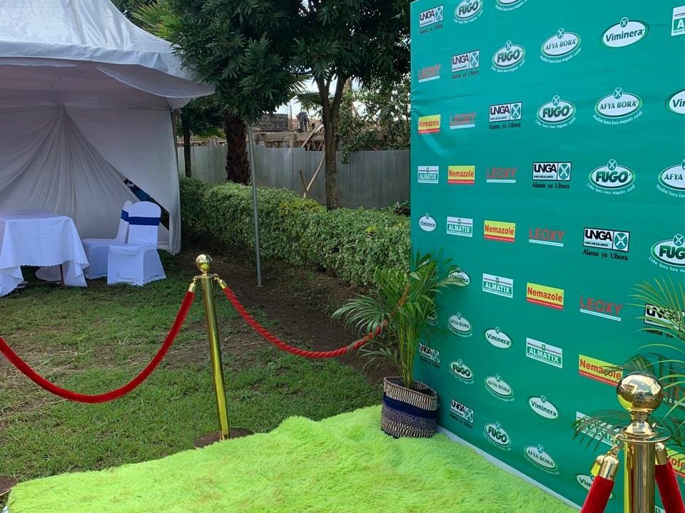 A brand portfolio wall under a marquee behind a red rope