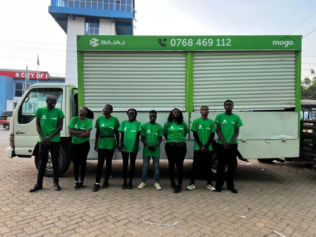A Mogo and Bajaj branded truck with an eight-person field team