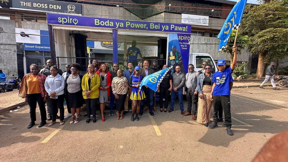A Spiro-branded dealer shop front with the dealer group standing in front of a branded truck