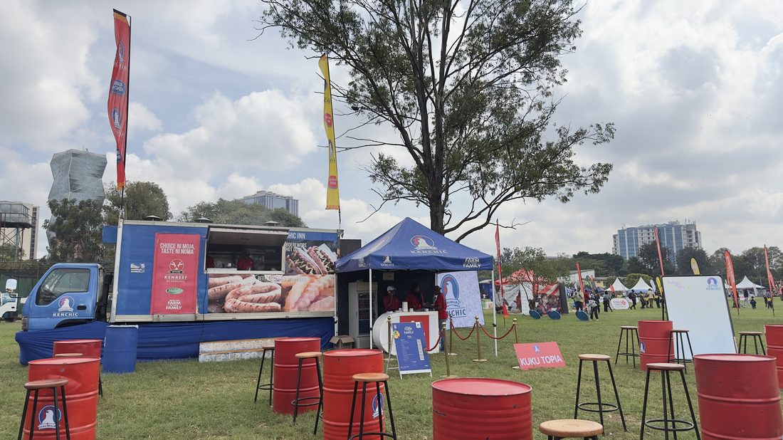 Red seating drums and branded units laid out across an event field