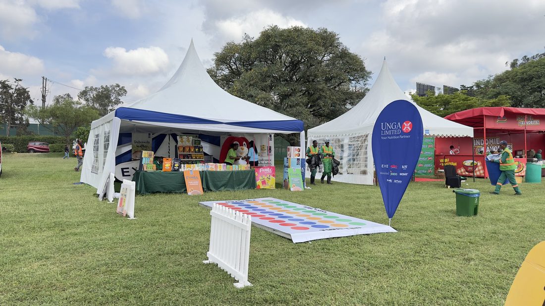A cluster of branded marquees on an open field
